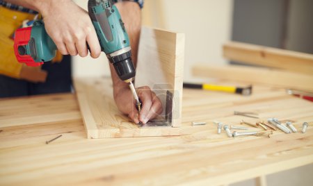 Carpenter working with drill