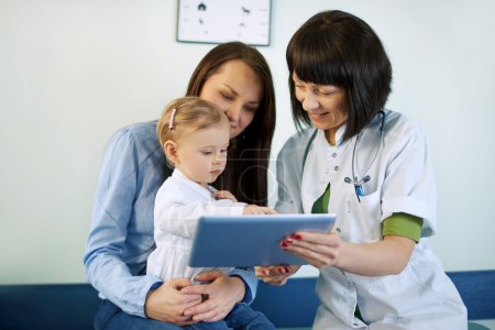 Doctor showing mother's medical results on the tablet