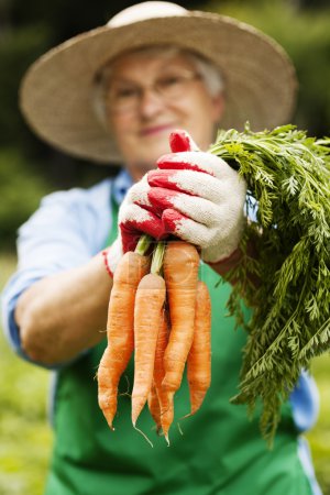 Senior woman with carrot