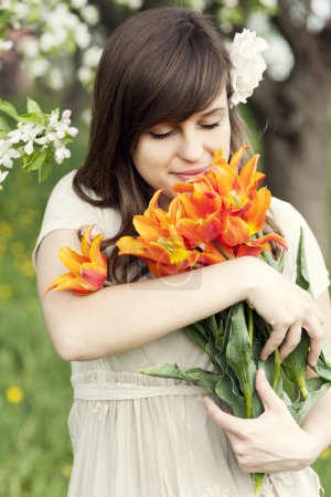 Woman enjoying the fragrance of flowers