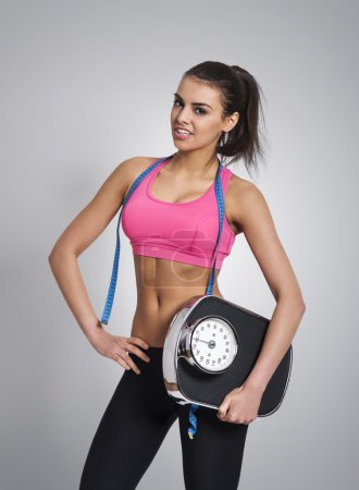 Woman holding weight scale
