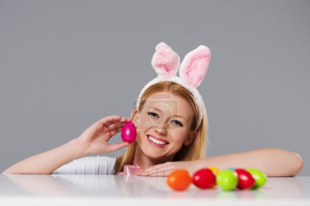 Blonde woman with bunny ears and easter eggs