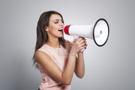 Woman screaming by megaphone