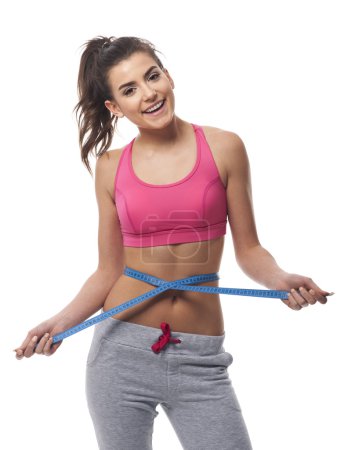 Woman measuring her waist line