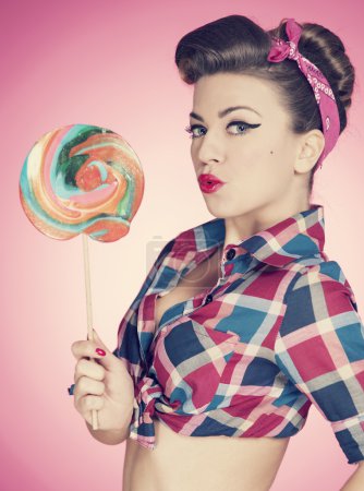 Retro sexy woman with large lollipop