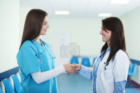 Doctors shaking hands in hospital