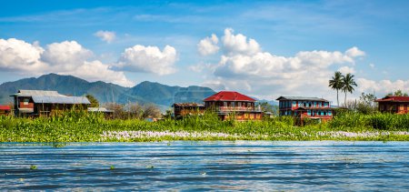 Ancient houses and their reflection in the water on the Inle Lake, Myanmar