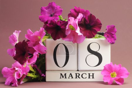 White block calendar for International Women's Day, March 8, decorated with pink and purple flowers (horizontal)