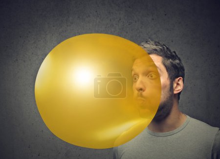 Man blowing a baloon