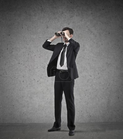 Businessman using a binoculars