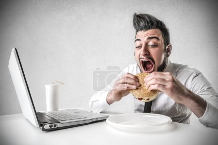 Businessman eating a hamburger