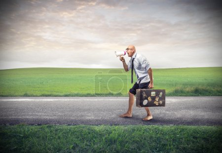 Poor businessman walking with his suitcase