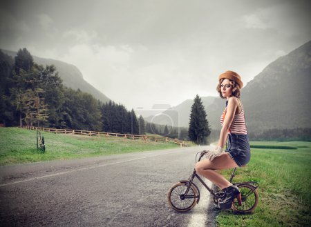 Young woman on a small bike