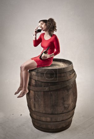Woman sitting on a barrel