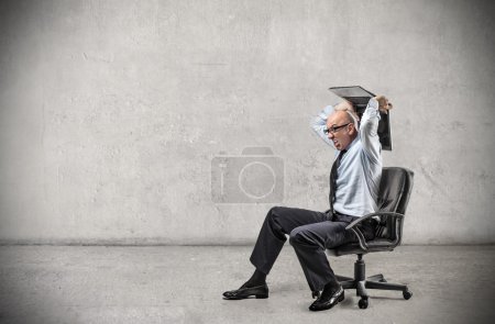 Angry businessman sitting on a chair