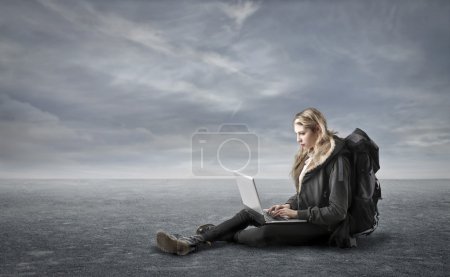 Young woman looking at her laptop