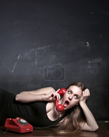 Astonished woman speaking at the phone