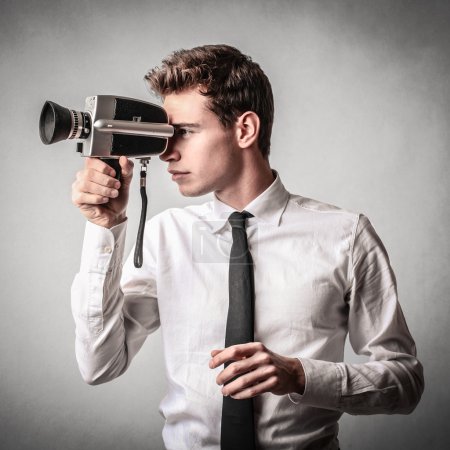 Young businessman using a camera