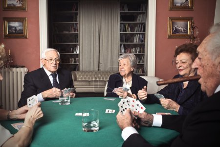 Old men and women playing poker