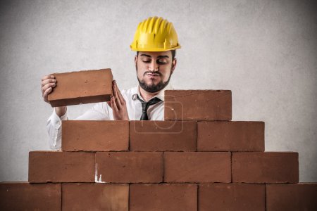 Businessman building a wall