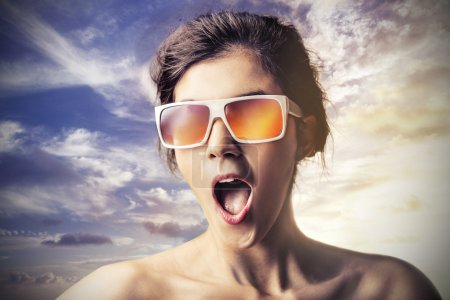 Surprised woman wearing sun glasses