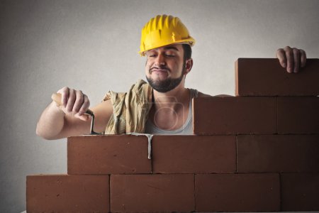 Happy bricklayer working
