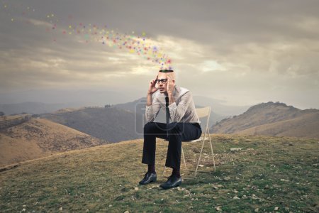 Man thinking on the top of a hill