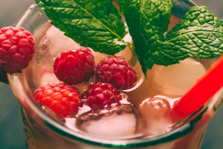 Red drink with raspberries, ginger and ice