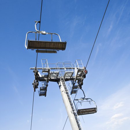 Chairlift in a blue sky background