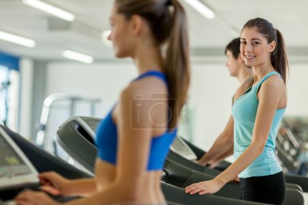 Happy young people on a treadmill