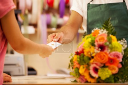 Woman is buying a colorful bouquet of flowers