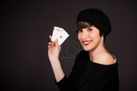 Smiling girl with french style outfit with four aces