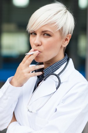 Female doctor is smoking