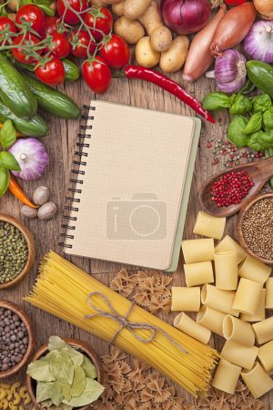 Fresh vegetables and blank recipe book