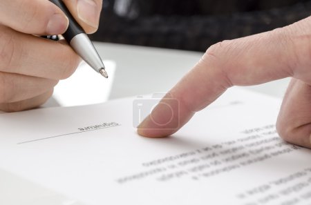 Woman signing a paper