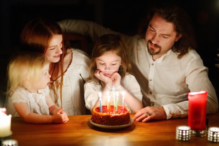 Family celebrating   daughter's birthday