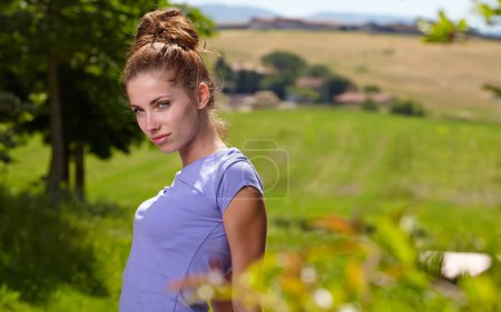Good morning in Tuscany. Fit woman front of Italy house.