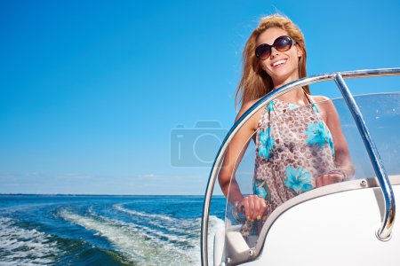 Young girl driving a motor boat
