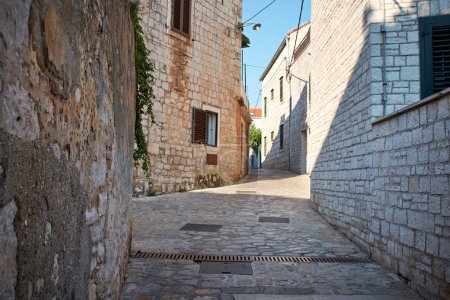 Narrow Alley With Old Buildings In Typical Croatia Medieval Town
