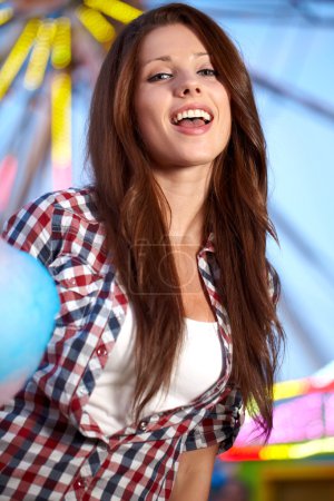 Smiling woman in amusement park.