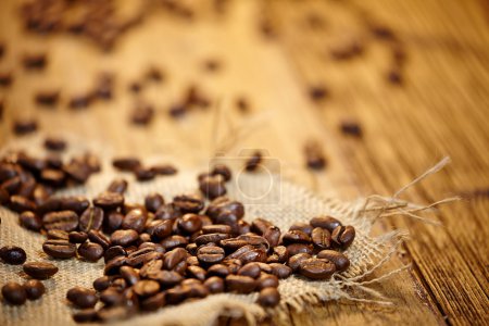 Fresh coffee beans on wood background, Macro close-up for design