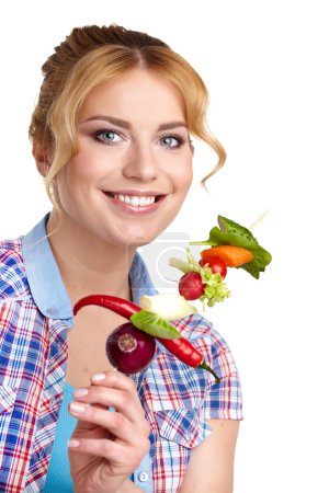 Woman holding vegetable skewers