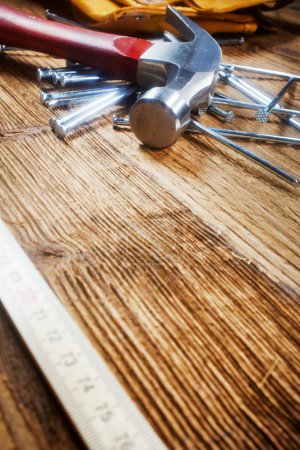 Hammer, nails, ruler on wood