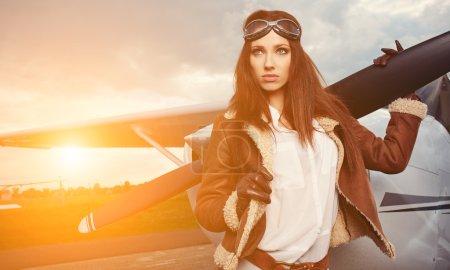 Woman pilot in front of airplane