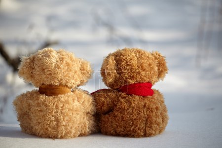Teddy bears on a snow around each