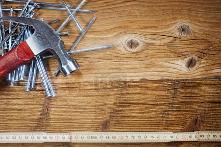 Hammer, nails, ruler on wood