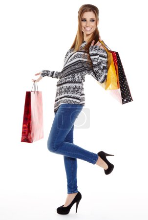Shopping woman walking and holding bags - isolated over white