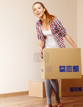 Young beautiful woman with packages for house moving