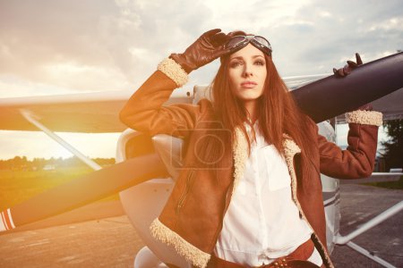 Woman pilot in front of airplane