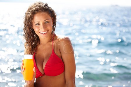 woman in bikini smear protective cream on the skin